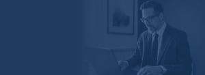 Man looking at a laptop with navy color overlay