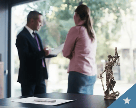 Insurance professionals talk in an office